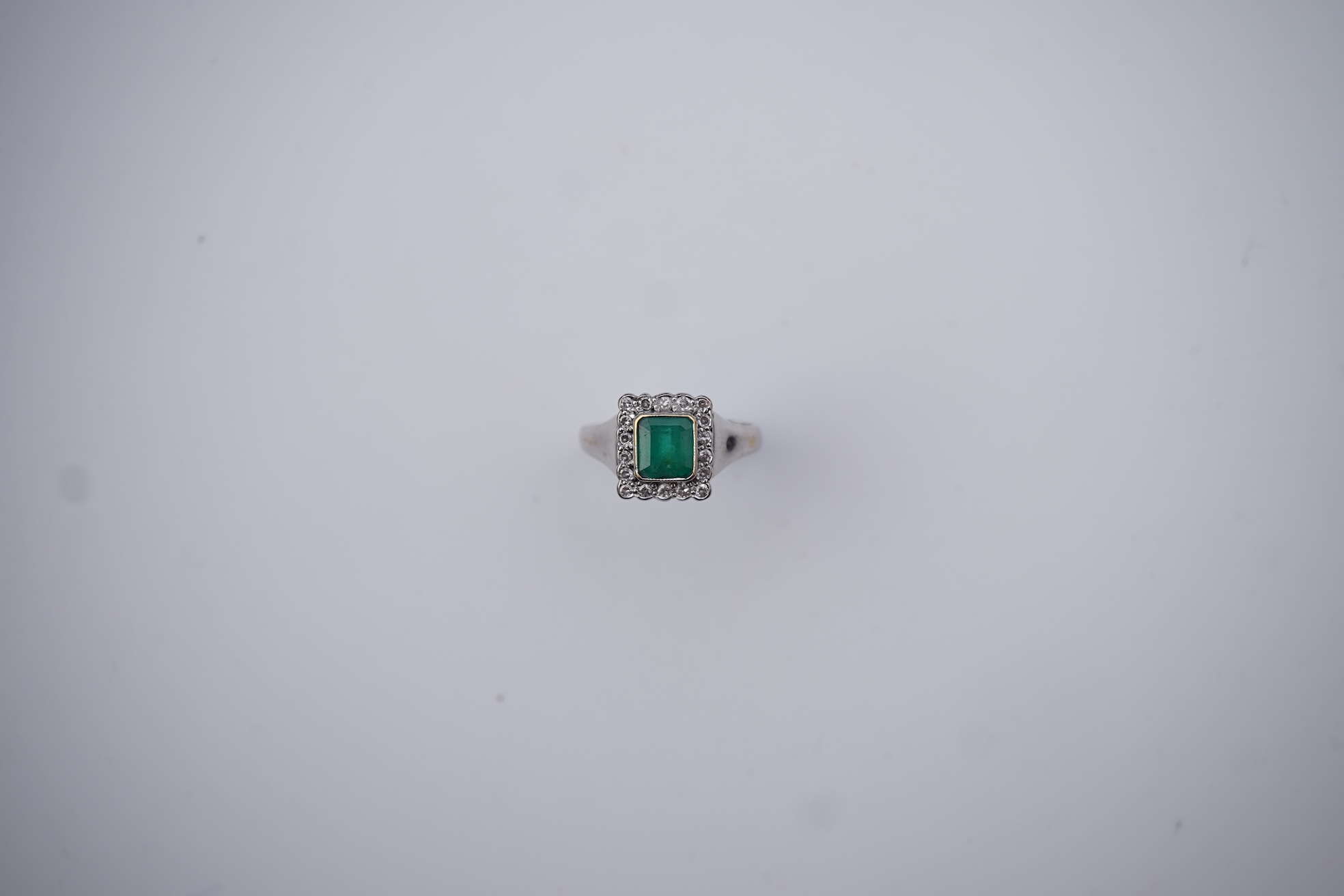 An emerald and diamond ring